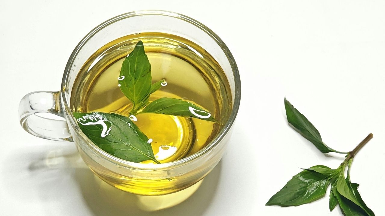 Mug of lemon tea sits on white table